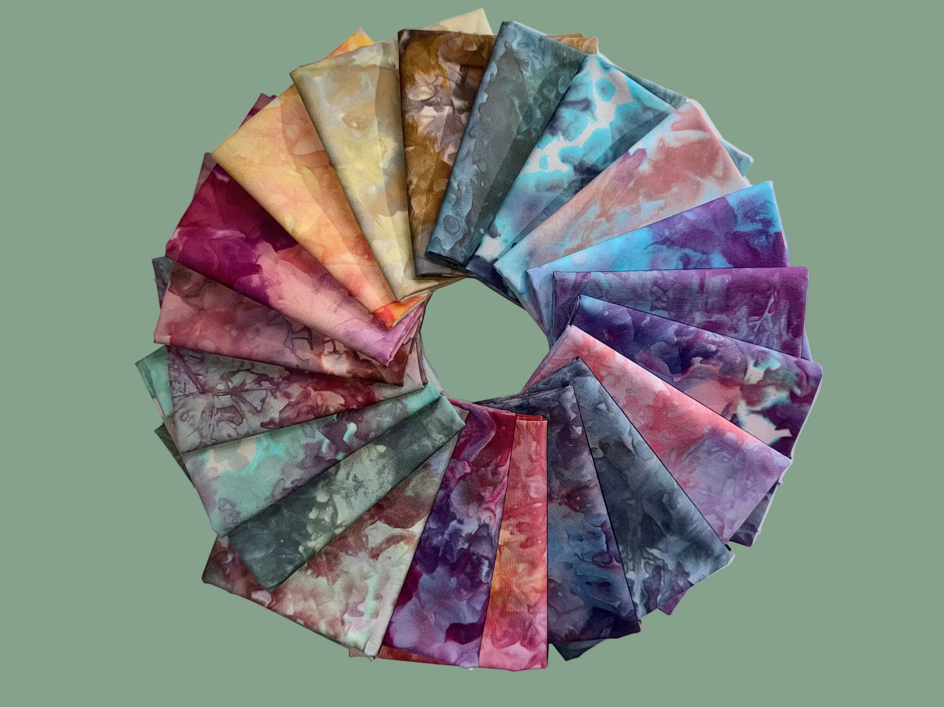 Circular arrangement of fabric swatches in various tie-dye patterns on a light blue background